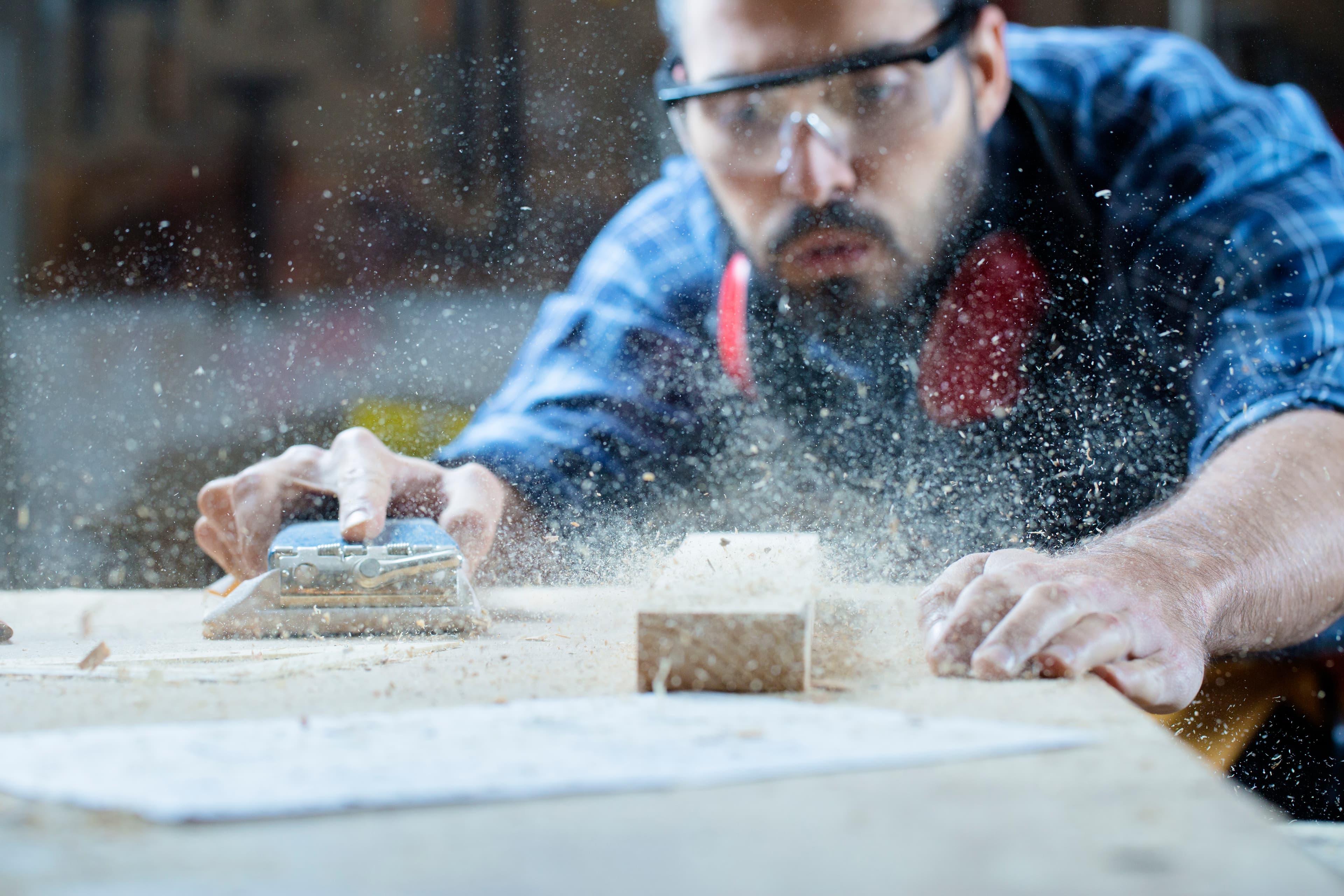 Norcospectra factory worker sanding wood